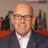 Portrait of Philip Matthews, Managing Director, Ireland, outside in front of a blurred brown background featuring a building and mix of natural and urban elements.