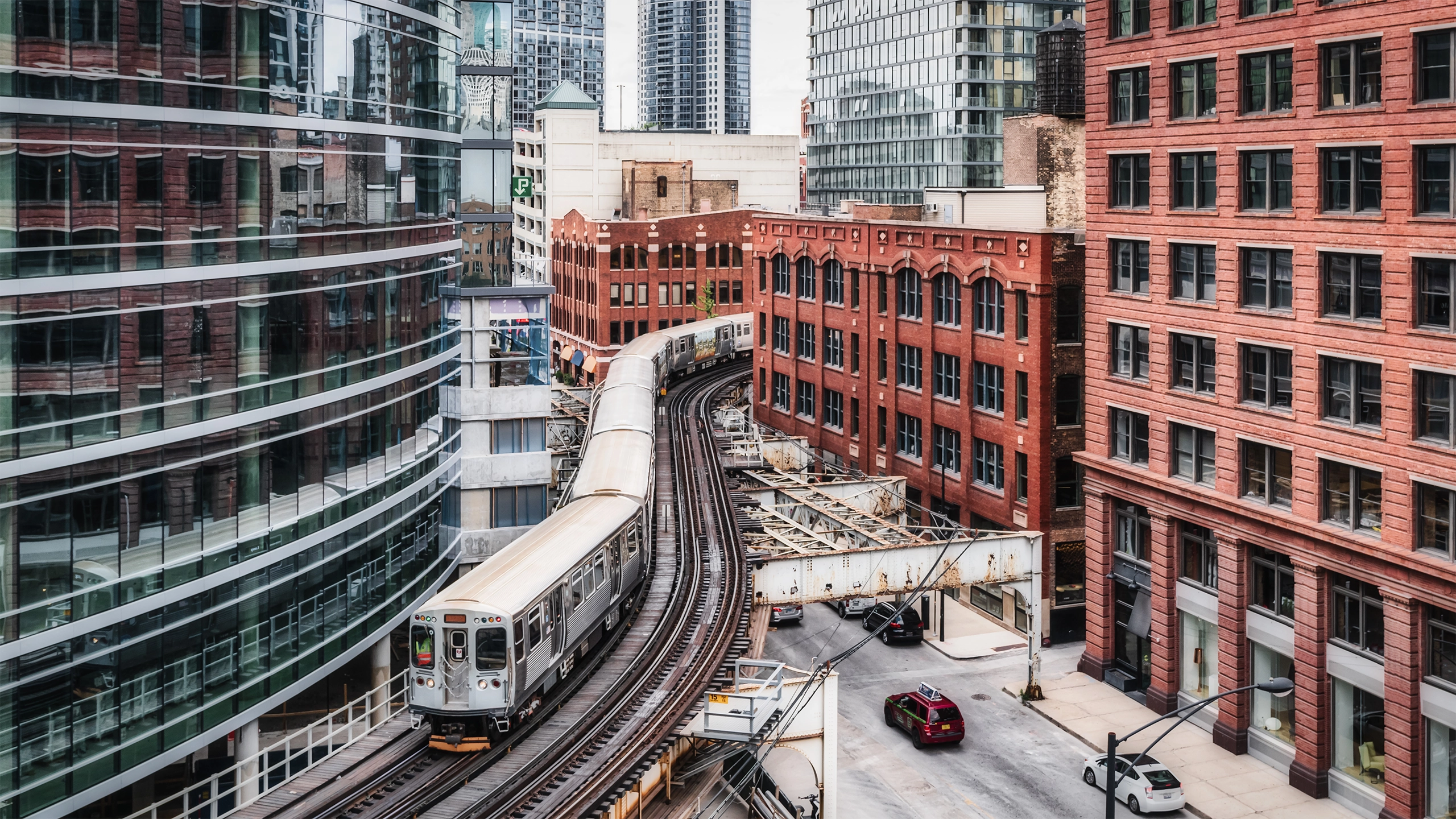 A train moving on tracks in between buildings in Chicago