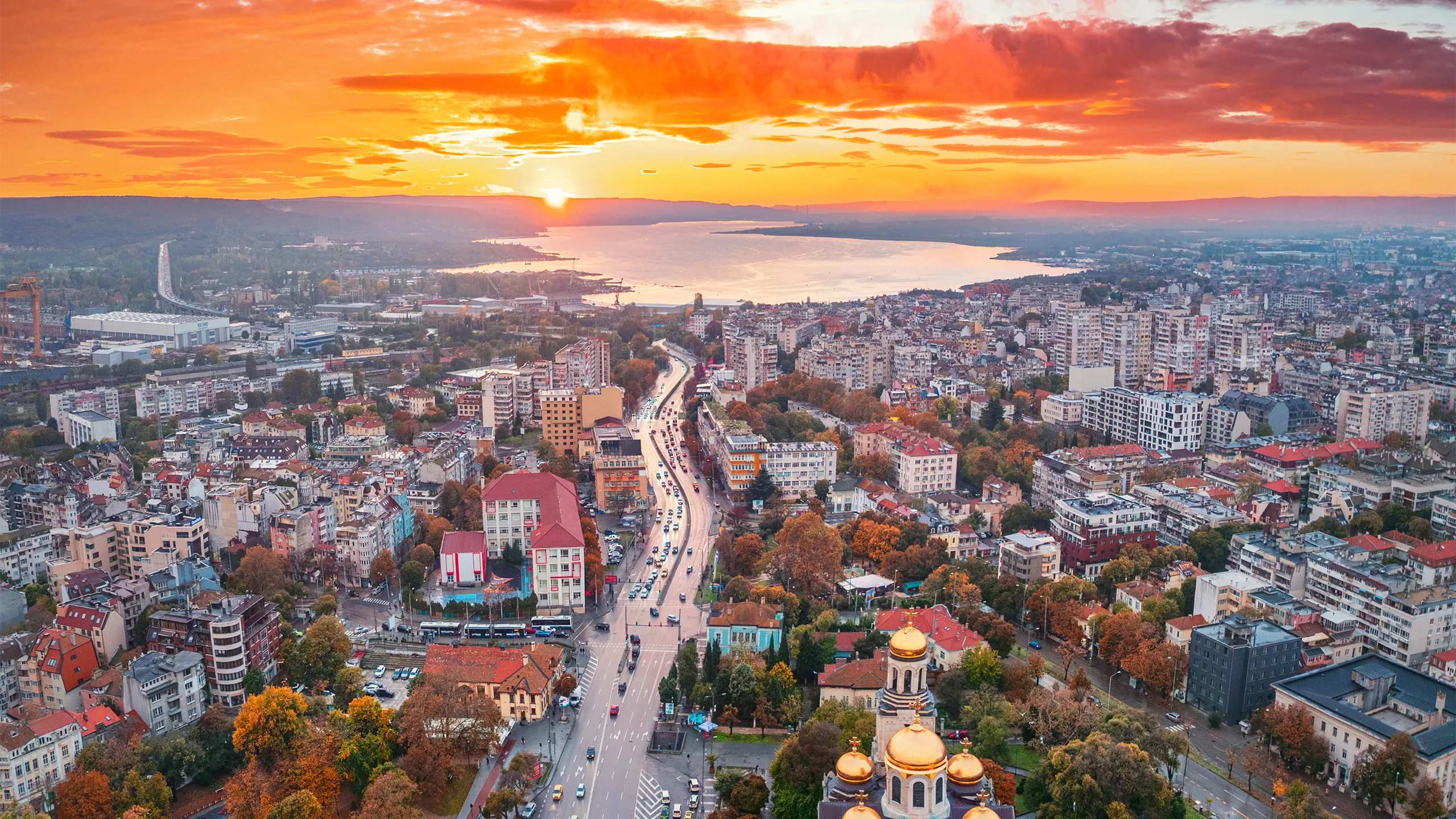 Aerial sunset panoramic autumn view of Varna city center, Bulgaria. The Cathedral of the Assumption, Asparuhovo bridge and Varna sea lake