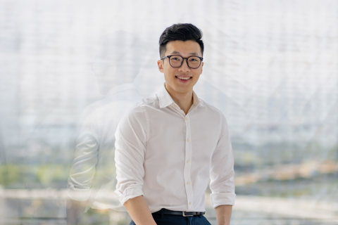 Portrait of Jia Jin Chin, Senior Cost Manager, Singapore, Standing against window pane.