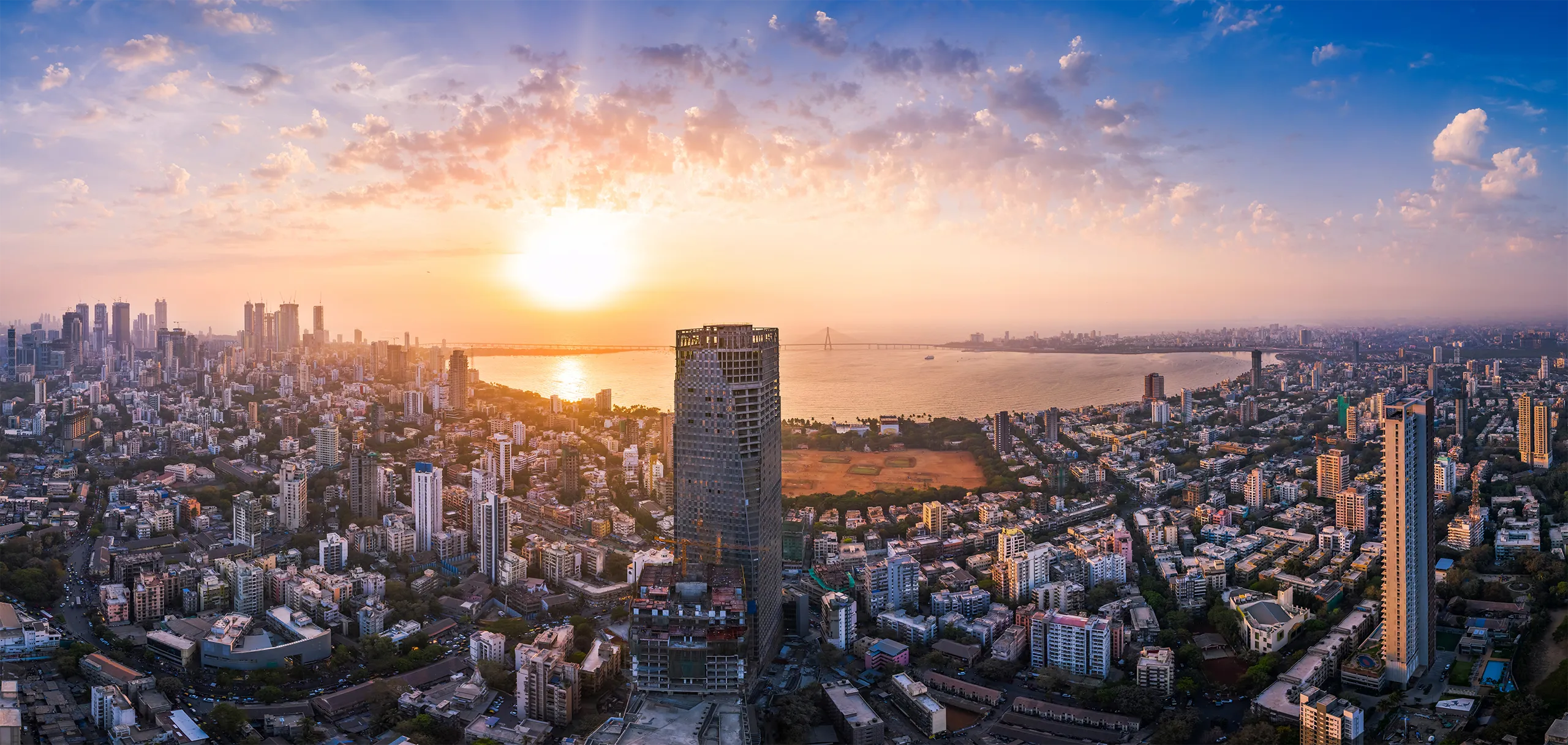 The Bandra Worli Sea Link is seen passing over the Mahim Bay, with the city around it. Dadar, Prabhadevi, Lower Parel, Worli, Matunga, Mahim and Bandra can be seen.