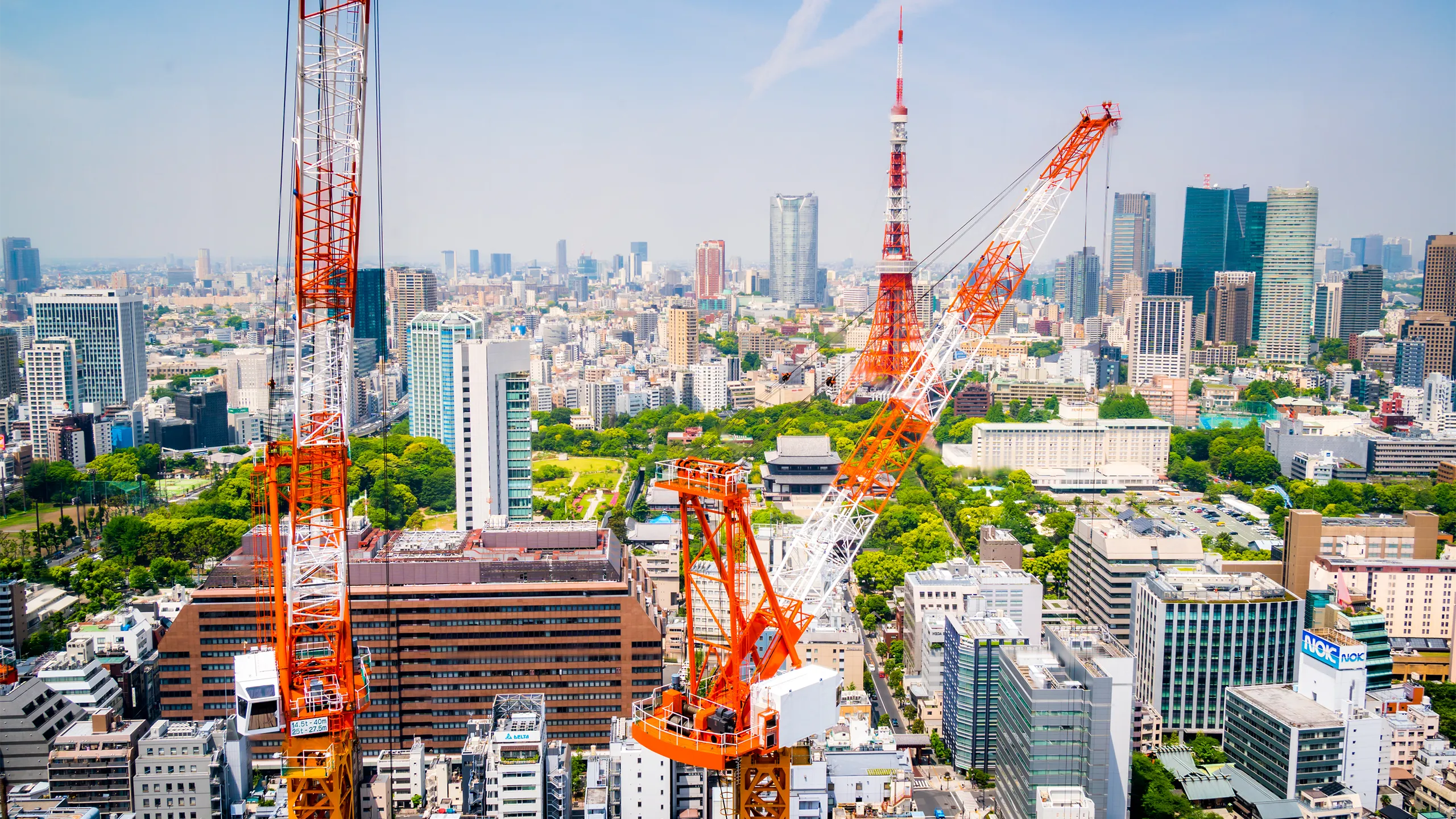 Aerial view of cranes in a construction site in downtown Tokyo.