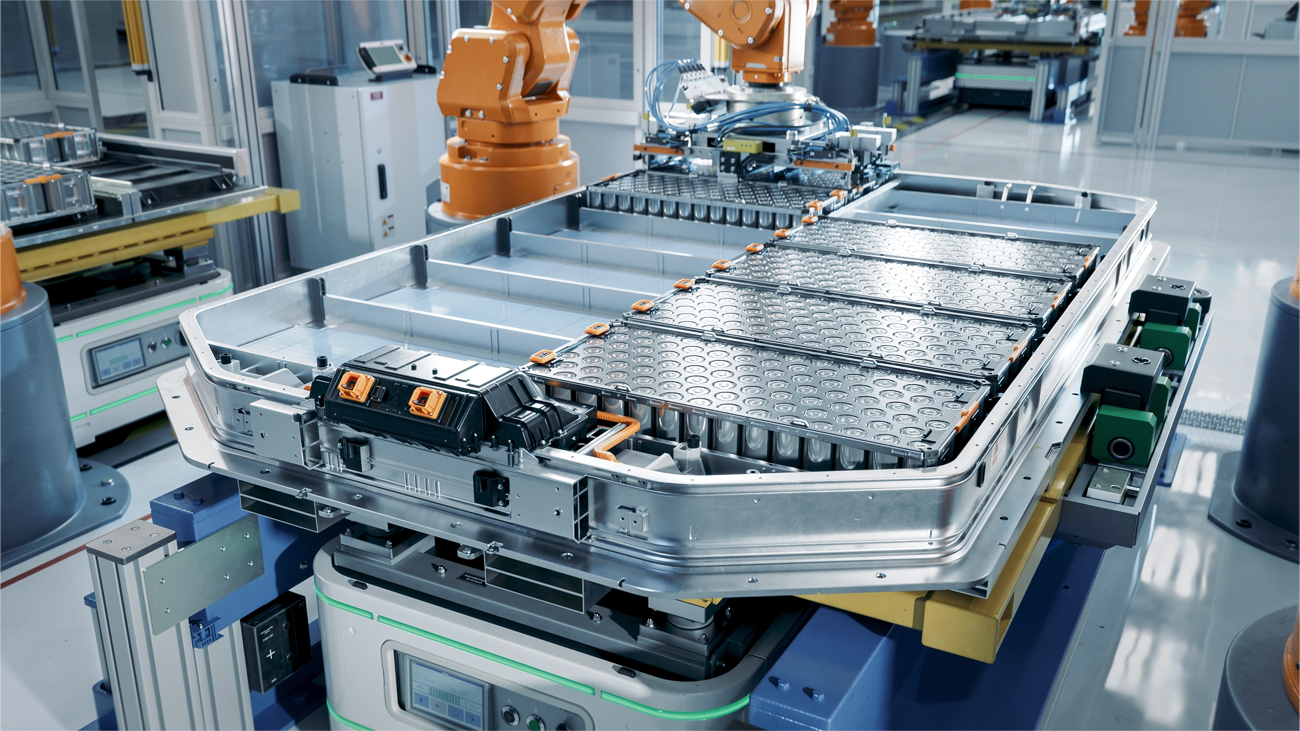 Interior of gigafactory with orange and steel machinery 