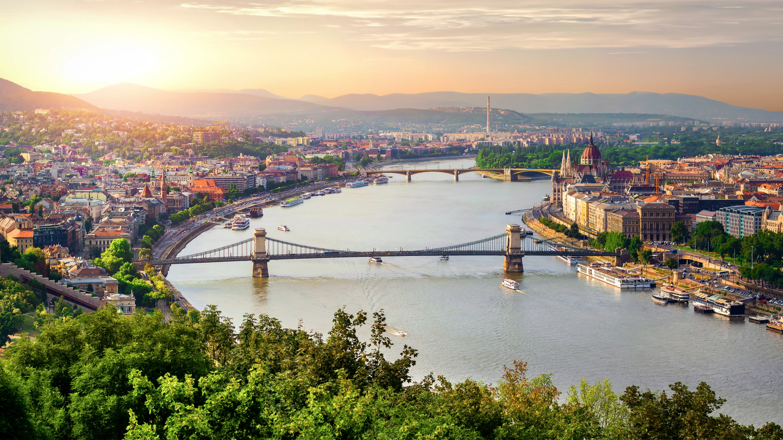 Panoramic sunset view of Budapest from Gellert Hill. Danube River, Chain Bridge, Parliament Building, Buda and Pest views. Budapest, Hungary.