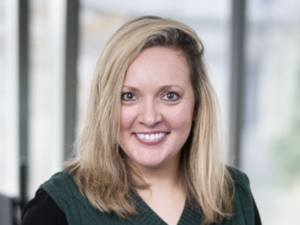 Portrait of Laura Stevens, Global Senior External Communications Manager, in a glass office