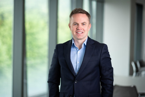 Alan Sinclair, UK Head of Energy and Natural Resources, in an office smiling in a suit
