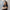 Portrait of Siti Norman, Director, Digital, Singapore, standing against white background and window.