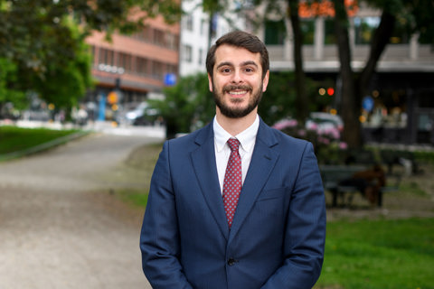 Portrait of Nima Aase, Managing Director, Scandinavia, outside in front street with trees and tall buildings,