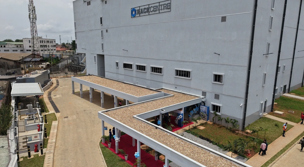 Ezteror view of Rack Centre, large industrial building with a covered walkway and people walking nearby.