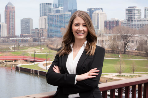 Portrait of Whitney Knuf Ahn, Vice President, Nashville Cost Centre Leader, outside in front of tall city buildings