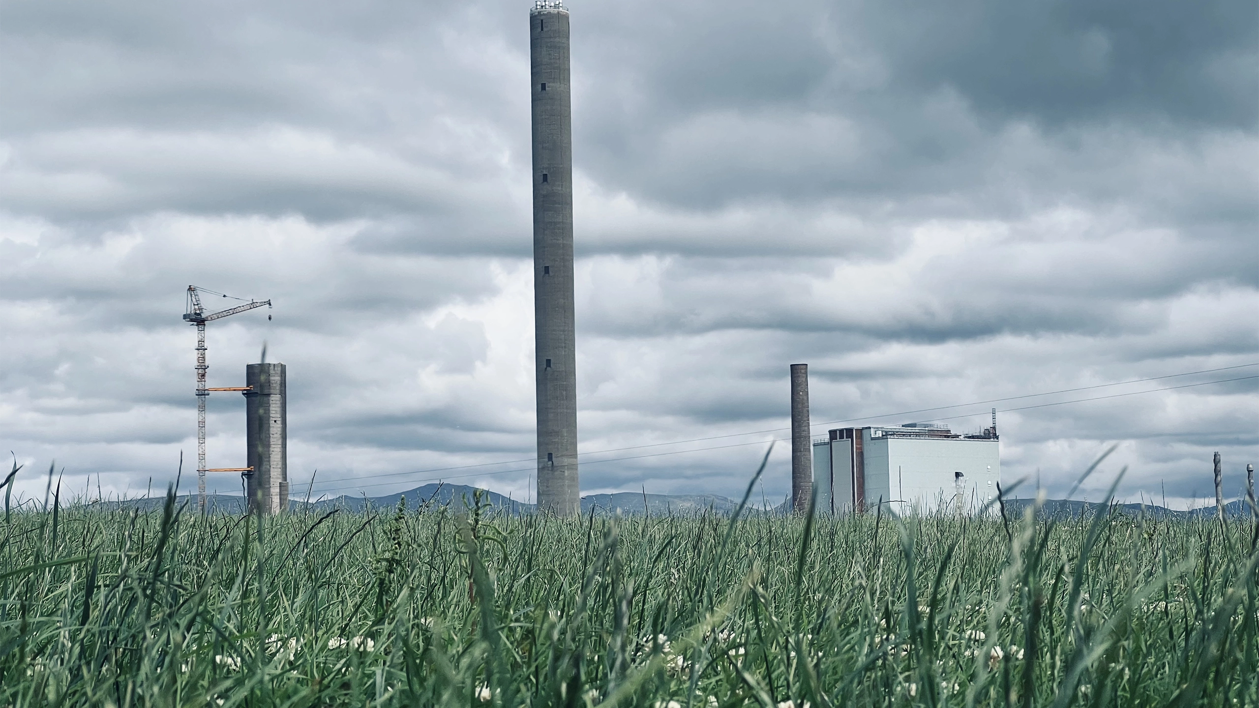 Factory in a landscape with green grass
