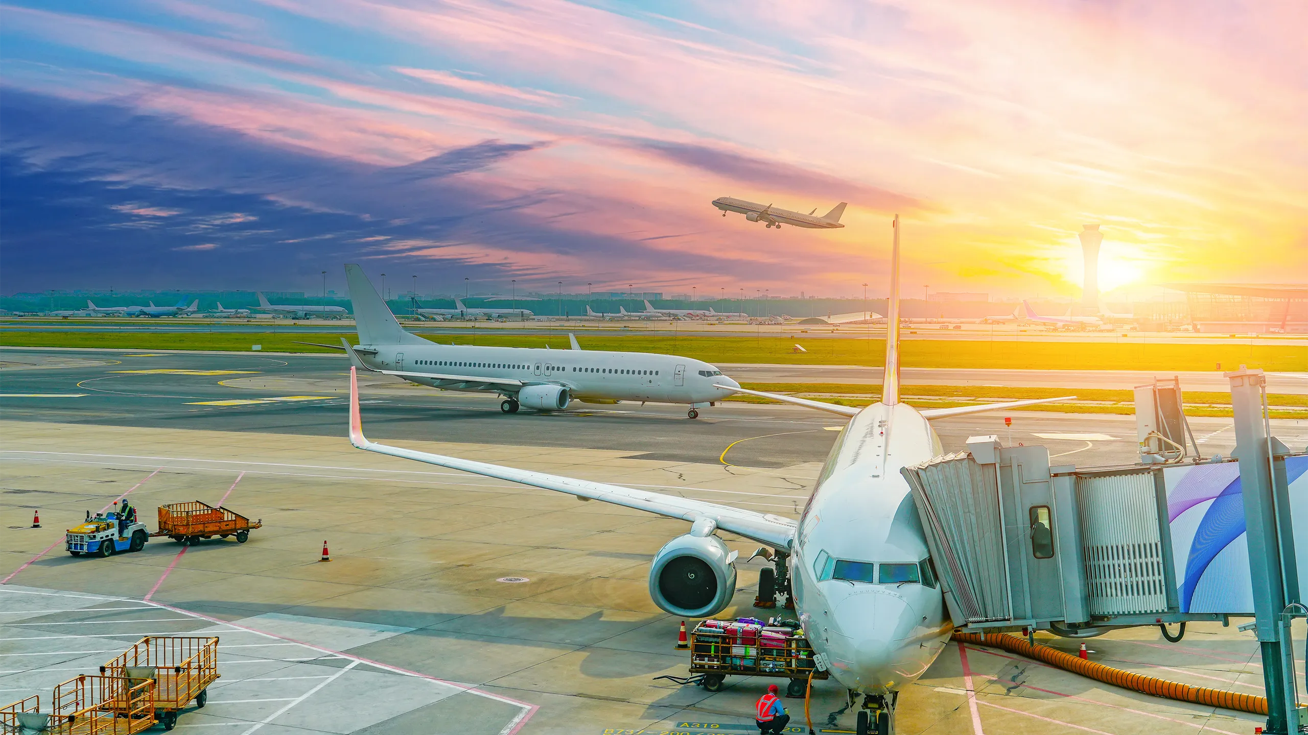 Flights management air control tower and passenger terminal in international airport with flying climb plane jet, taxiing, ready for departure gangway in clouds sky sunset dawn.