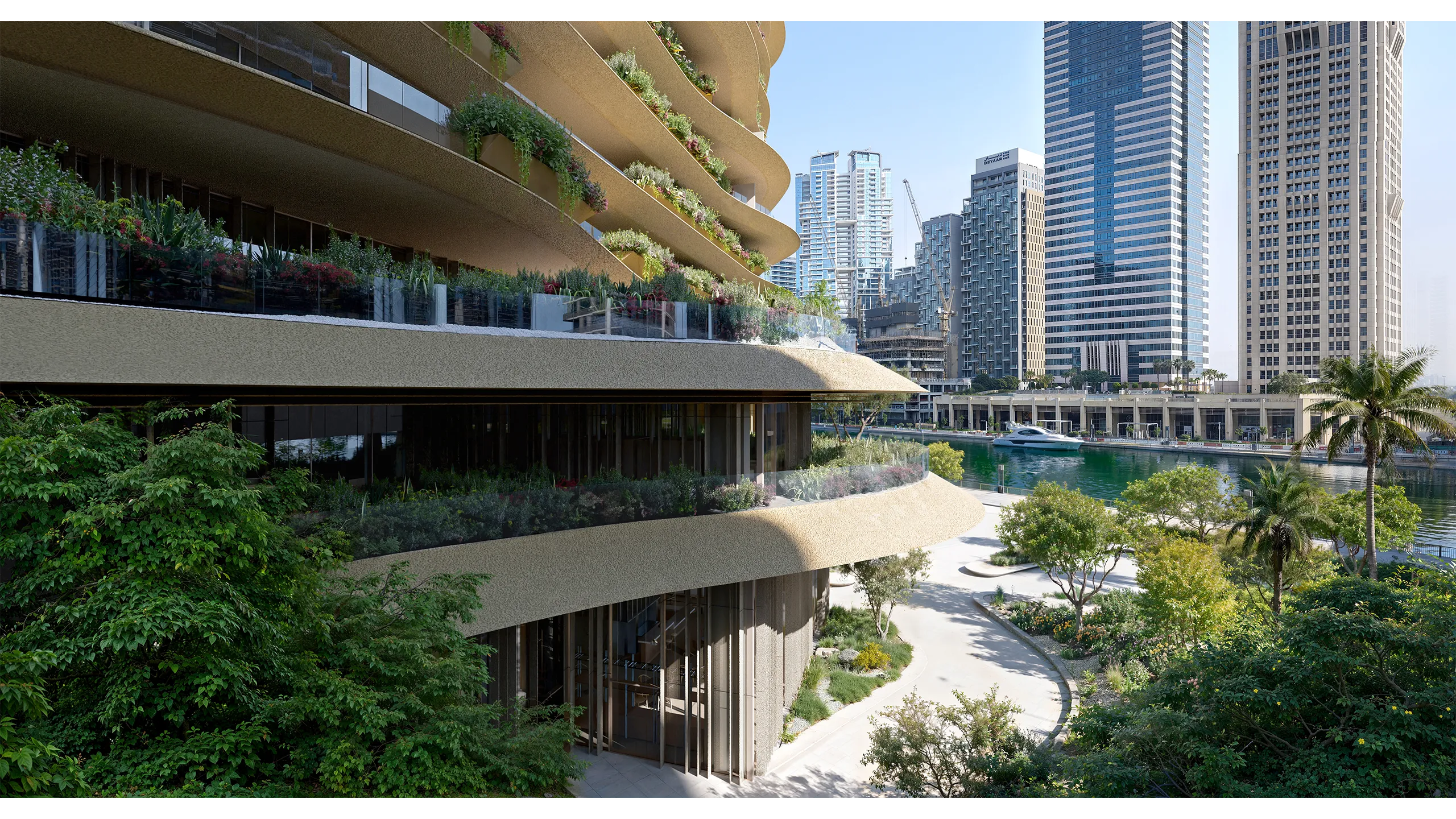 Modern curved building featuring greenery and city skyline in the background