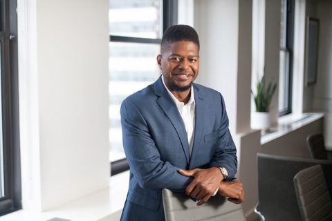 Wayne Lambert, Director of Supplier Diversity, US, in an office with white walls and beige chairs and a pot plant
